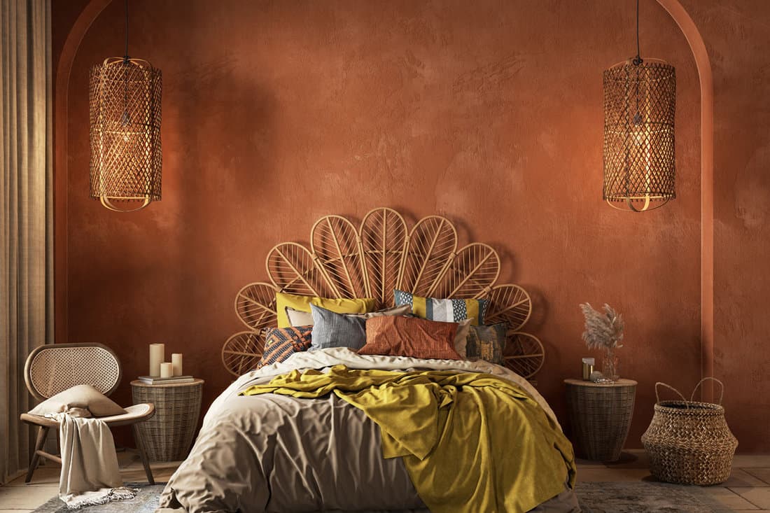 Orange boho style interior with armchair, dresser and decor