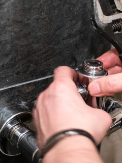 A plumber installs diverter on shower faucet valve in shower room, How Does A Shower Faucet Cartridge Work And How Long Should It Last? [Basics For Beginners]