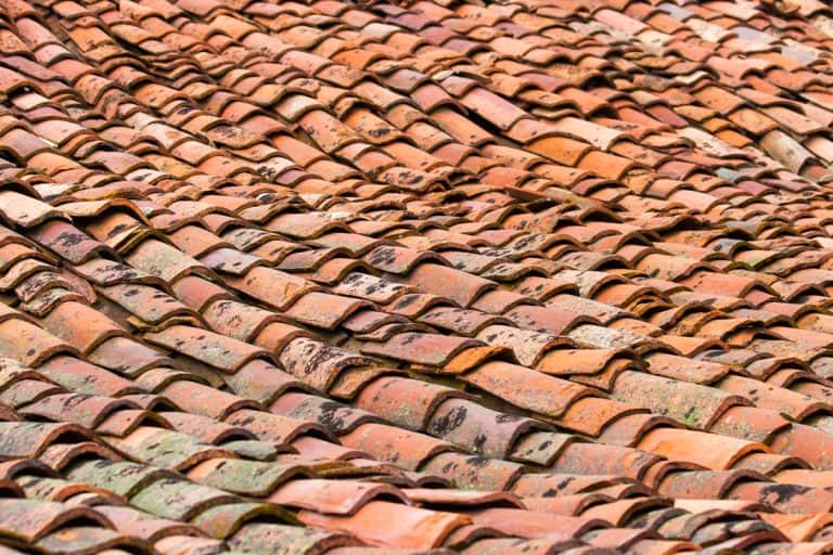 Roof somewhat depressed in the center with old clay tiles red, What Causes A Sagging Roof? A Guide For Homeowners