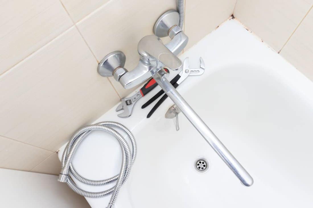 Shower water tap faucet repair, calcified shower hose with limescale replacement in bathroom