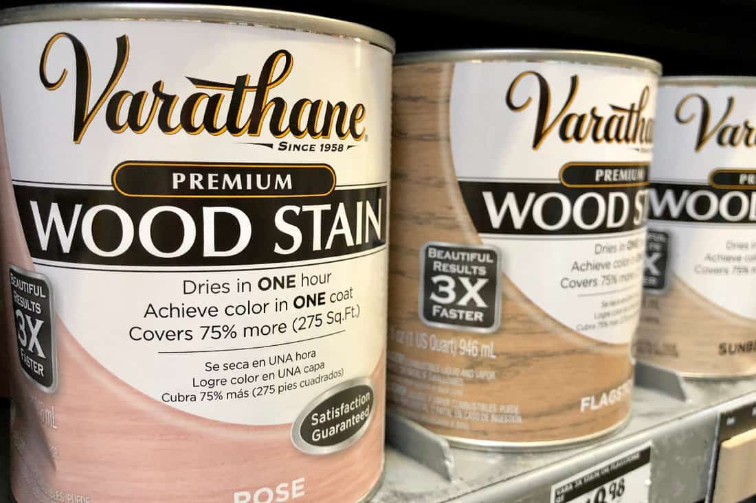Varathane polyurethane wood stain in quart sized cans on a store shelf