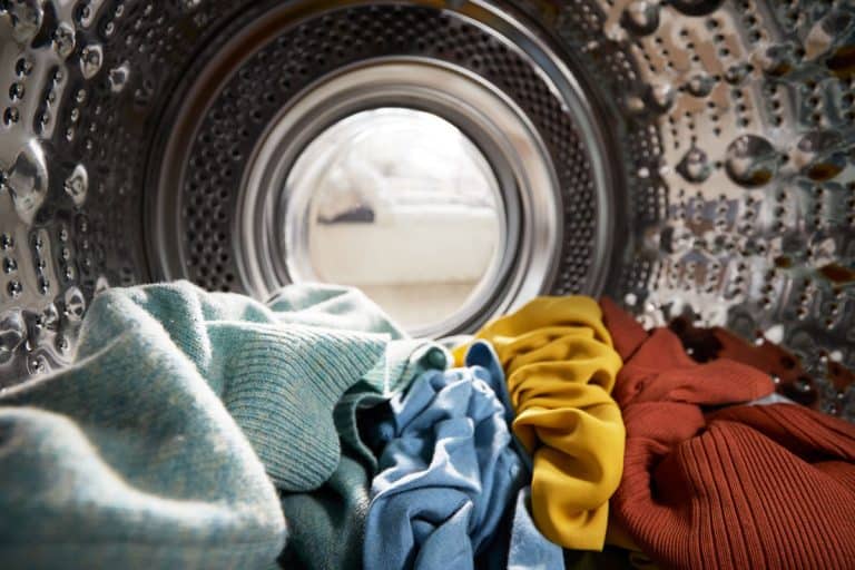 View Looking Out From Inside Washing Machine Filled With Laundry colored clothes, What Temperature Water Shrinks Clothes?