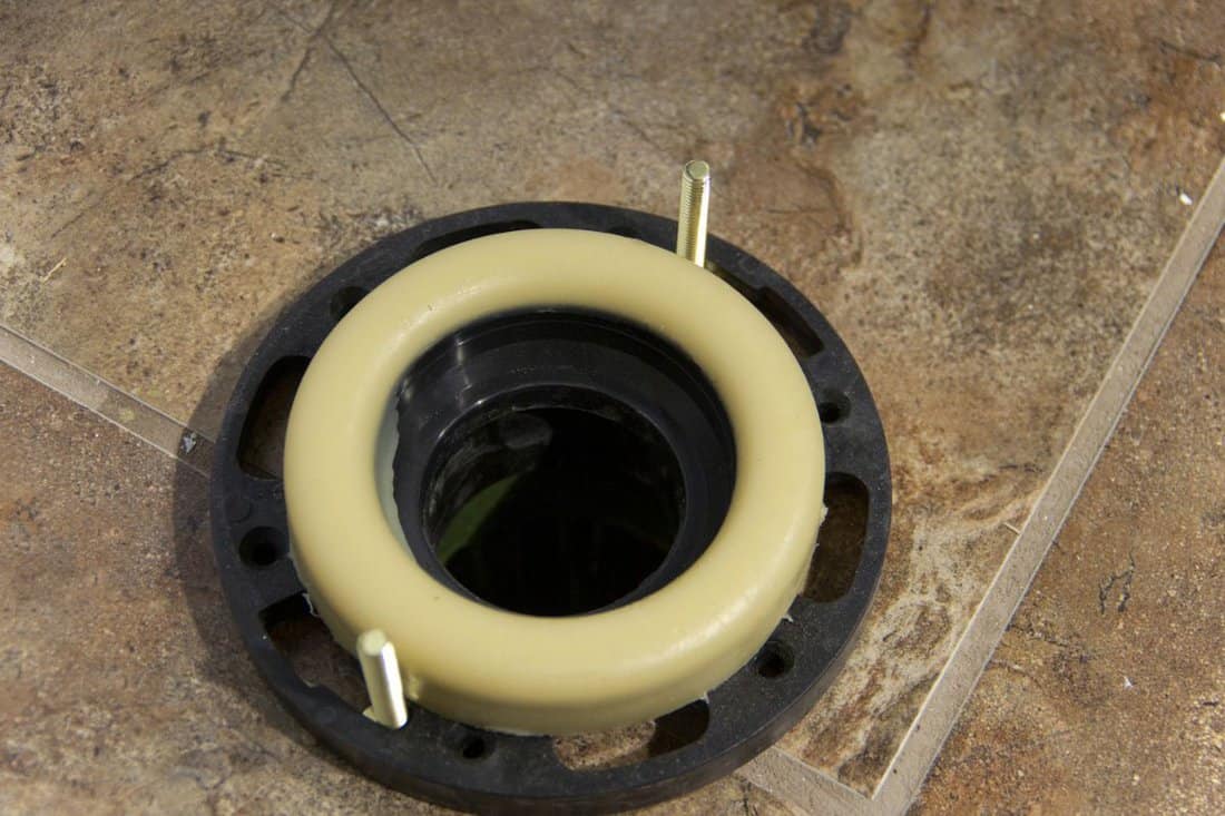 View of the wax gasket used to seal the base of a toilet, during new house construction.