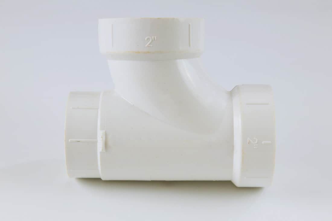 White polypropylene PVC polymer female pipe tee connection on a white background