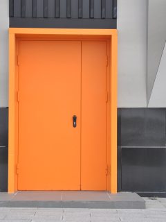 closed metal fire door in orange color. entrance - What Kind Of Paint To Use On An Interior Metal Door