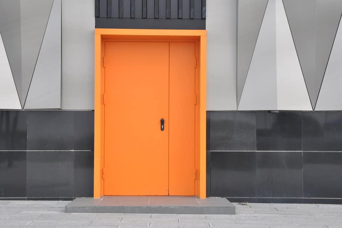 closed metal fire door in orange color. entrance