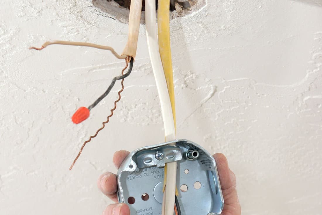 electrician-threading-wire-through-regulation-fan