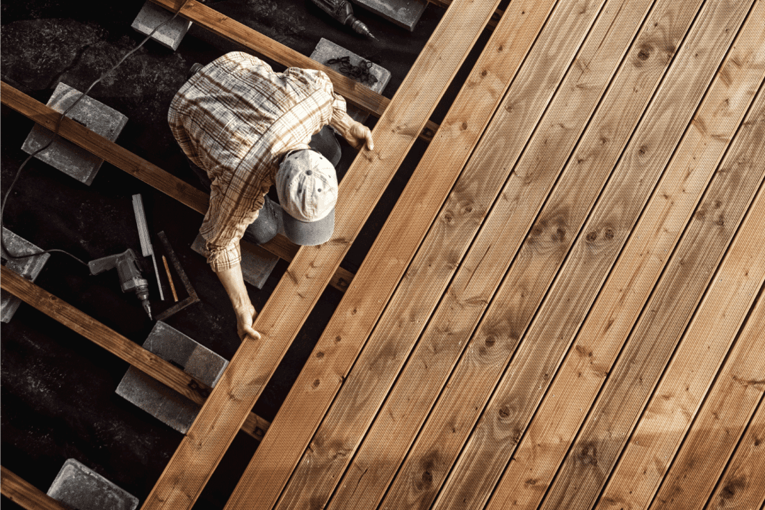 man installing the Wooden Flooring of a deck
