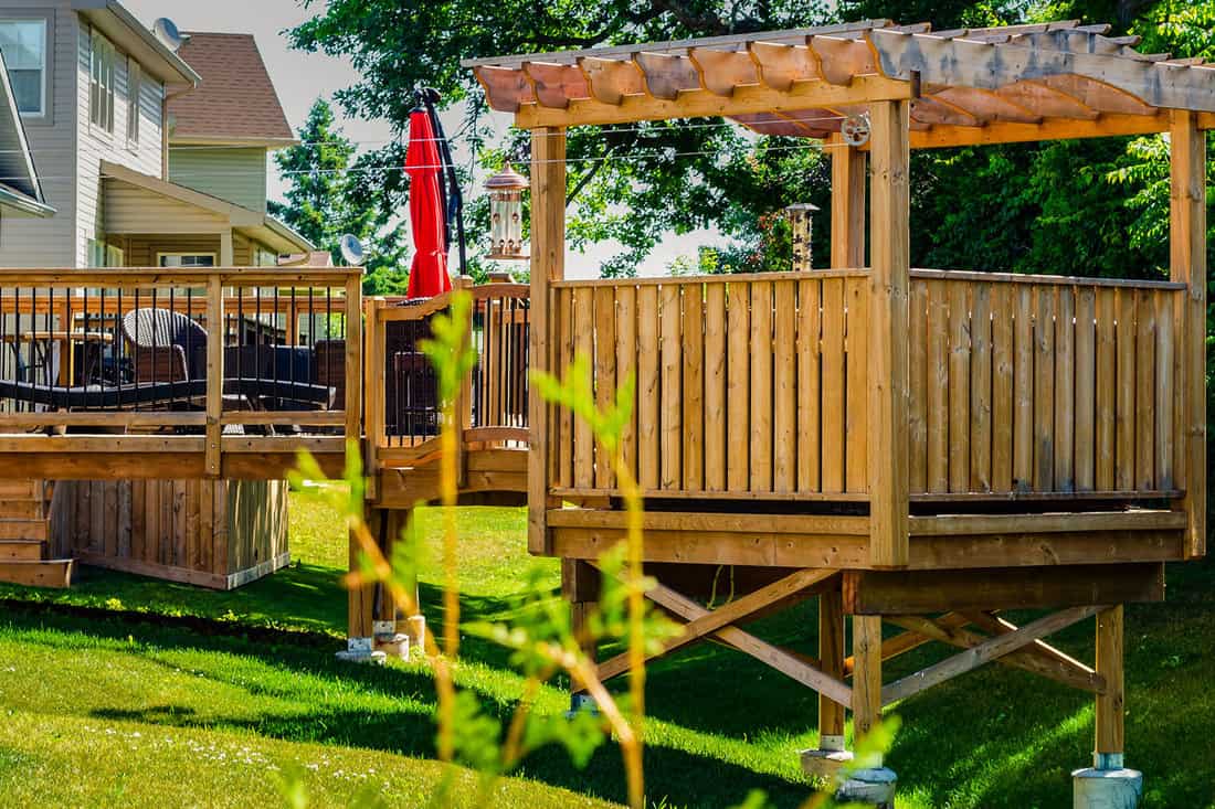 raised-backyard-wooden-deck-gazebo-treed
