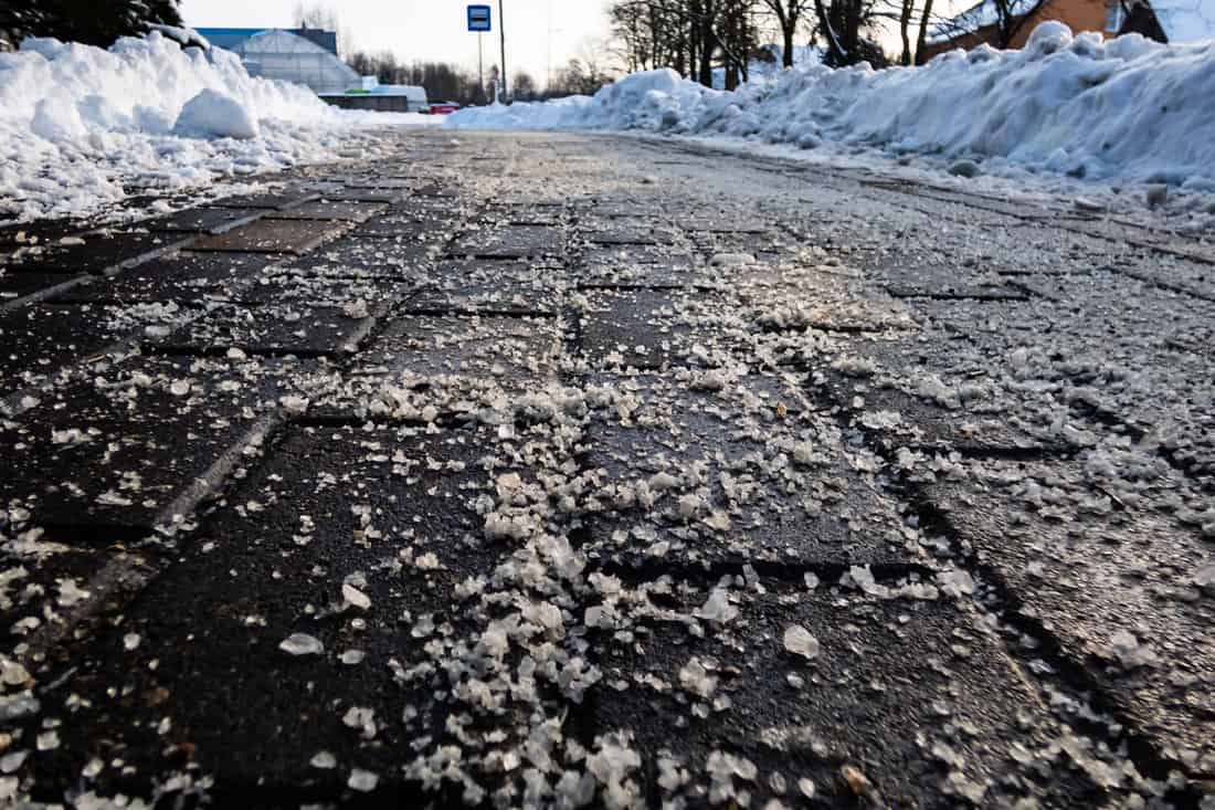 salt-grains-on-icy-sidewalk-surface