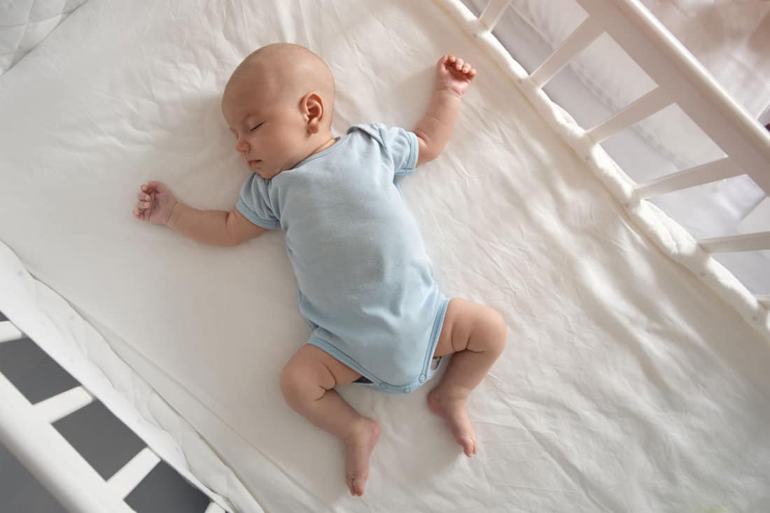 top-view-wide-angle-sleeping-newborn