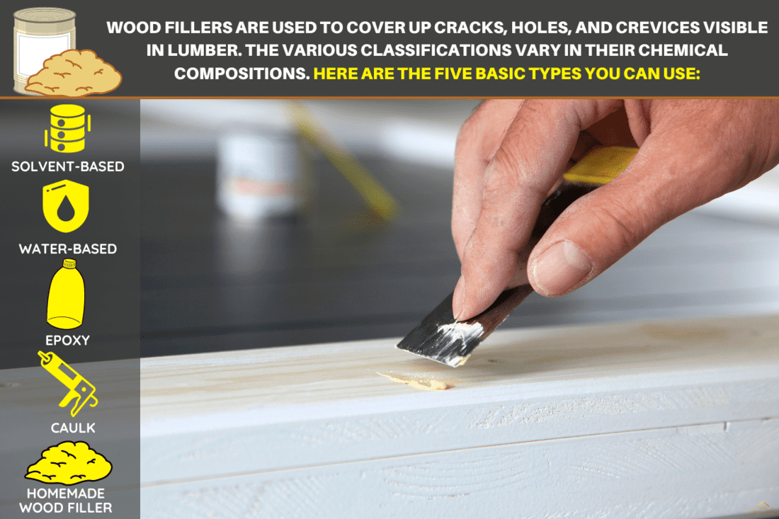 woodwork. Putty knife in man's hand. DIY worker applying filler to the wood. Removing holes from a wood surface. Preparation of wood before impregnation with varnish. Application of putty. - 5 Types Of Wood Filler