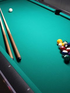 A pool table, set up for a game, Can I Use Candle Wax For My Pool Table?