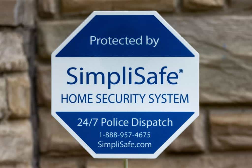 A SimpliSafe sign outside a house