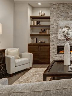 A living room interior in gray and brown colors features stone fireplace with built-in shelves and cabinets, 14 Paint Color Ideas For A Family Room With A Stone Fireplace