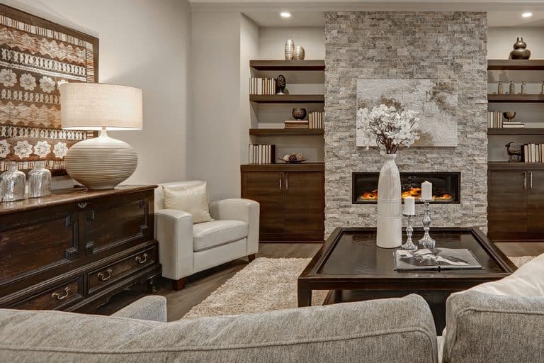 A living room interior in gray and brown colors features stone fireplace with built-in shelves and cabinets, 14 Paint Color Ideas For A Family Room With A Stone Fireplace