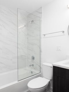 Spacious bathroom in gray tones with heated floors, walk-in shower, double sink vanity and skylights. Northwest, USA, How Wide Should A Shower Be?