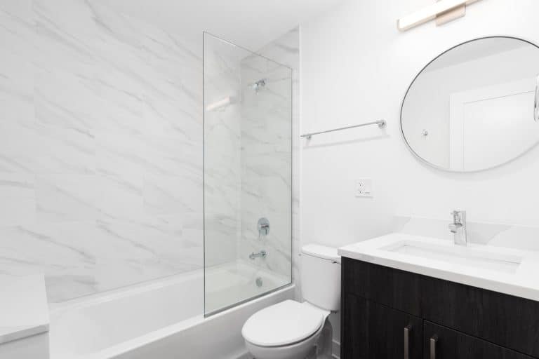 Spacious bathroom in gray tones with heated floors, walk-in shower, double sink vanity and skylights. Northwest, USA, How Wide Should A Shower Be?
