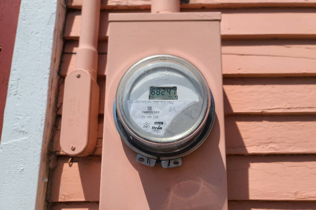 An Itron electrical meter on the siding of a house