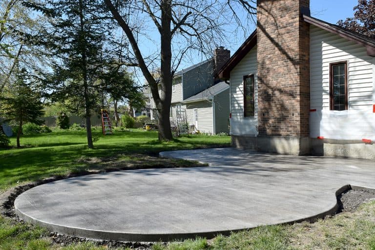 Backyard patio construction with a concrete cement foundation, How To Fix Concrete Patio Slope