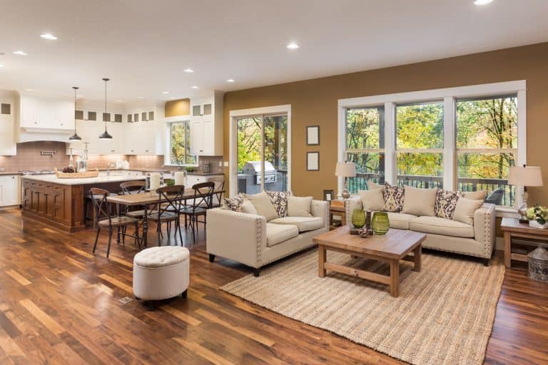 Beautiful living room interior with hardwood floors and view of kitchen in new luxury home, Why Is My Kitchen Floor Higher Than The Living Room?