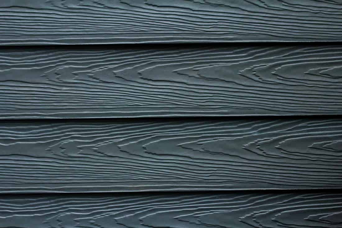 Close up dark blue wood substitute board and high quality of fiber board texture and background for design and architect, Beautiful wooden plank patterns from cement striped wood wall 