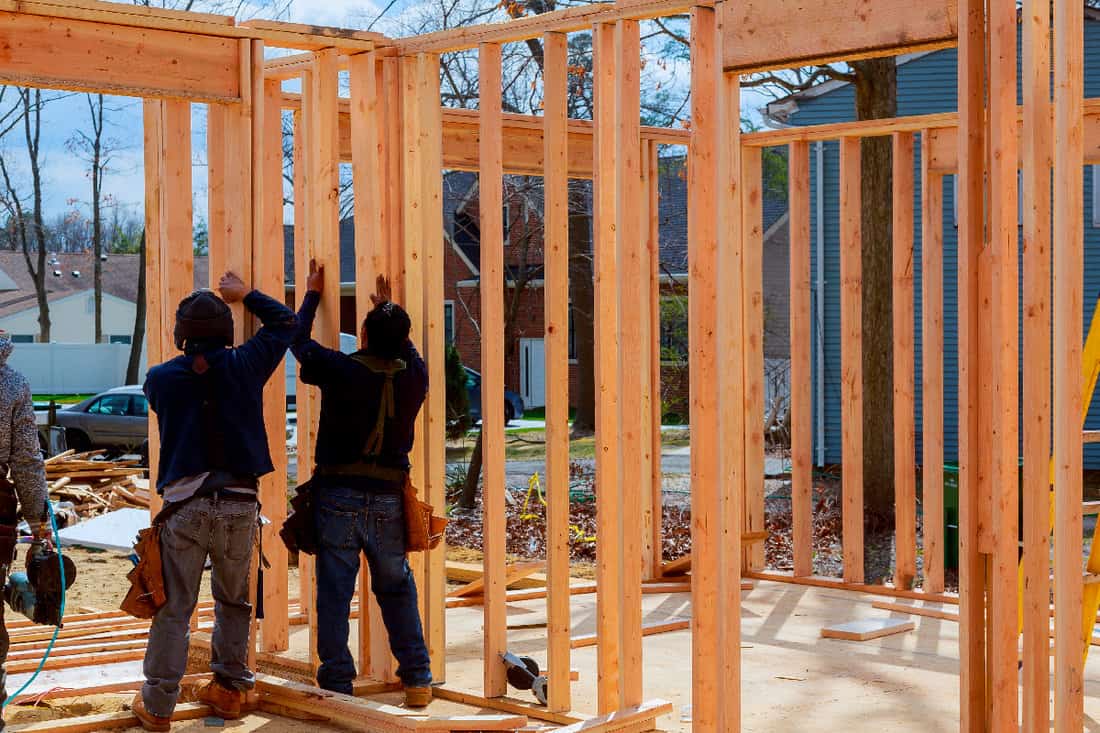 Construction worker building timber frame in new home