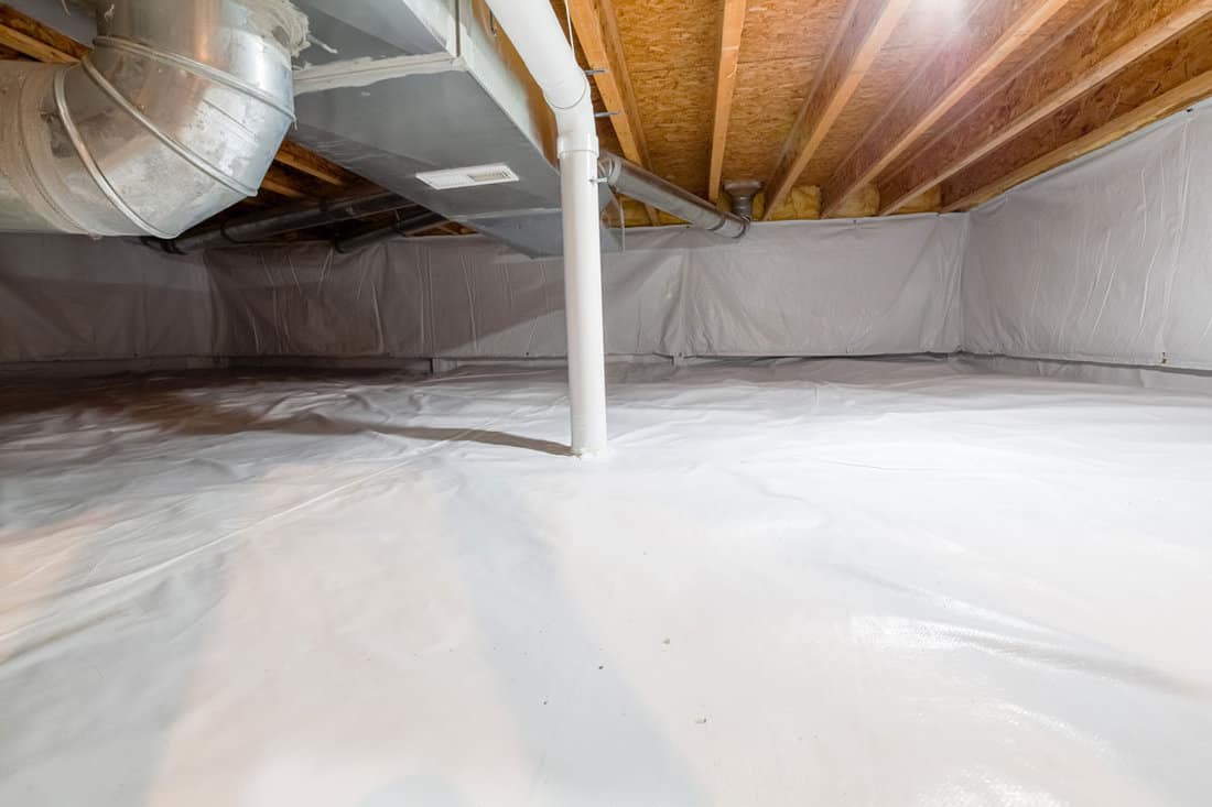 Crawl space fully encapsulated with thermoregulatory blankets and dimple board and pipes in basement location