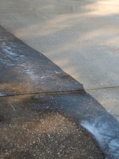Dirty concrete and cleaned concrete by a pressure washer, Do You Need To Rinse Bleach Off Concrete?