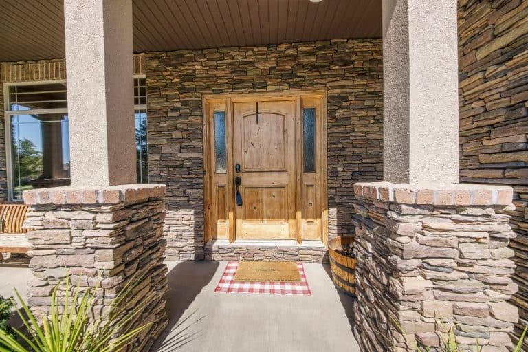 Entrance exterior of a house with stone veneer siding. - How To Install TandoStone Siding [Step By Step Guide]