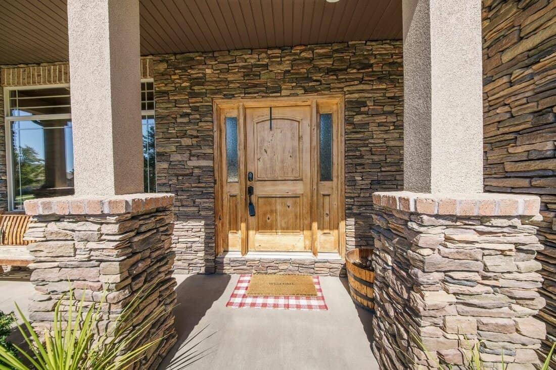 Entrance exterior of a house with stone veneer siding