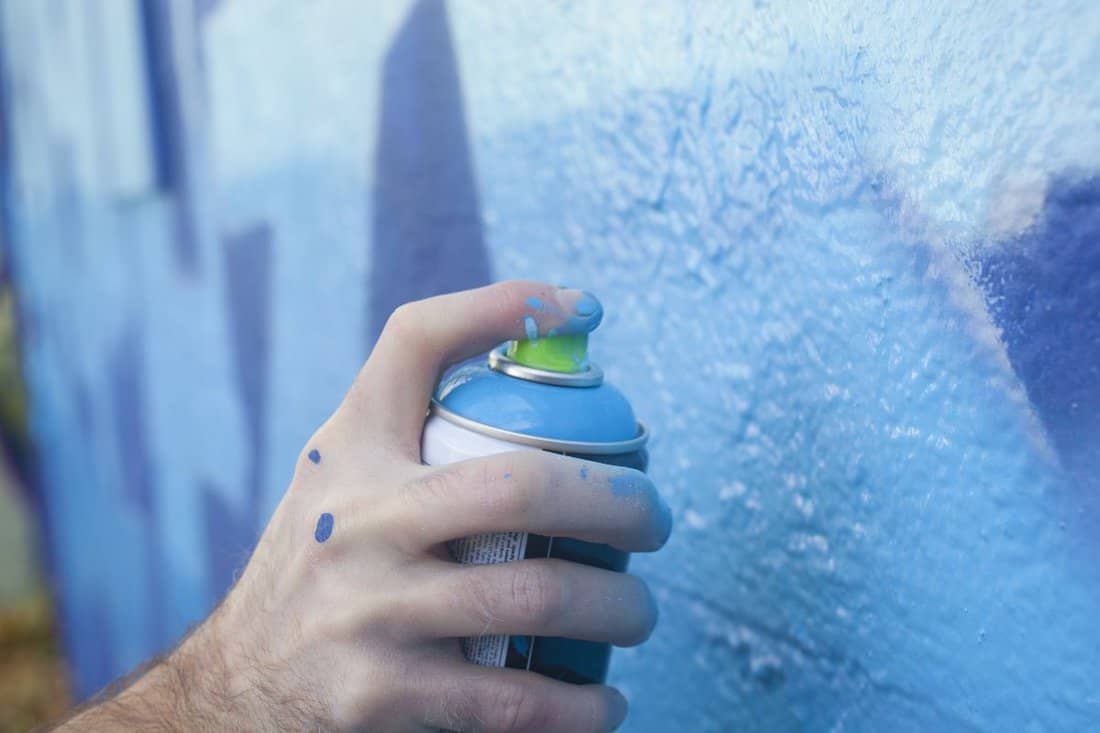Hand Holding a Spray Paint Can 