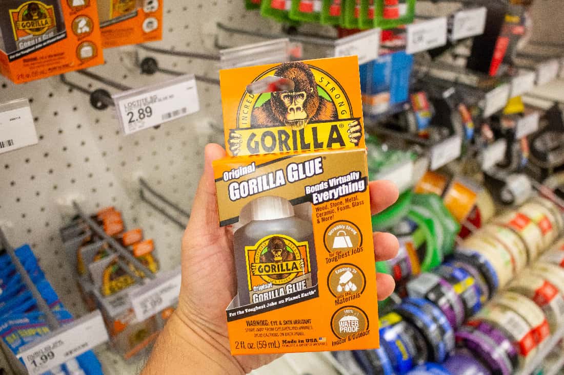 Hand holds a package of Gorilla glue at a local department store