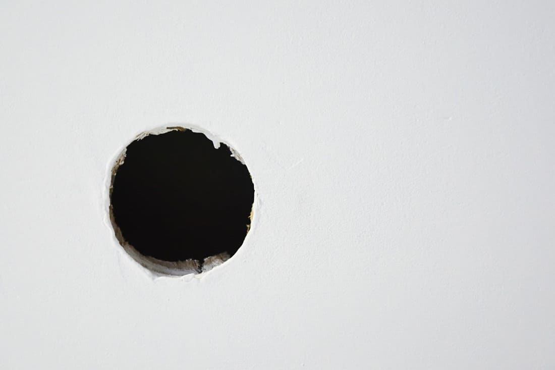Hole on the white wall.