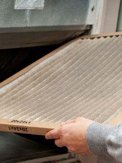 Home owner changing dirty air filter, How To Clean And Recharge K&N Air Filter [Step By Step Guide]