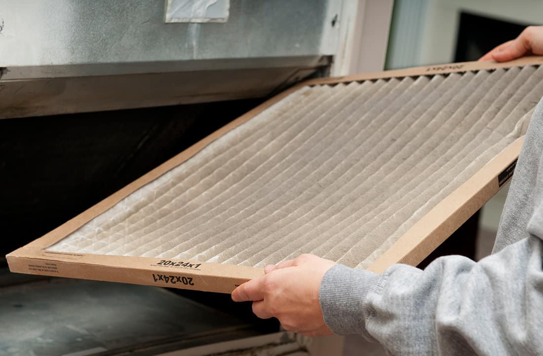 Home owner changing their dirty air filter