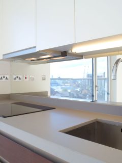 Interior of a newly furnished modern kitchen with flourescent lights and white walls, 9 Ideas To Replace The Fluorescent Lights In Your Kitchen [With Pictures]