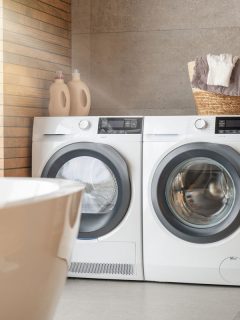 Interior of a real laundry room with a washing machine at home, Why Isn't My Dryer Getting Hot Enough To Dry Clothes? [How To Fix With Step-By-Step Guide]