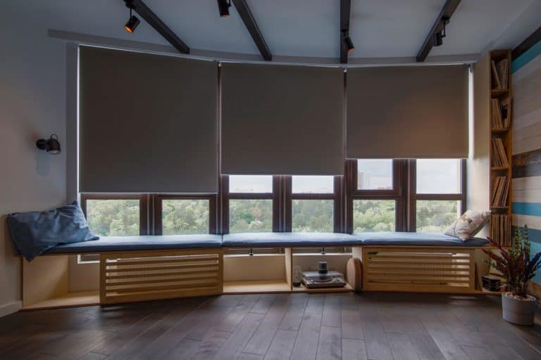 Motorized roller shades in the interior. Automatic roller blinds beige color on big glass windows, How To Install Lutron Serena Shades [Step By Step Guide]