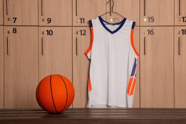 A jersey uniform on a hanger in locker room, How To Hang A Jersey On A Wall [5 Creative Ways To Inspire You]