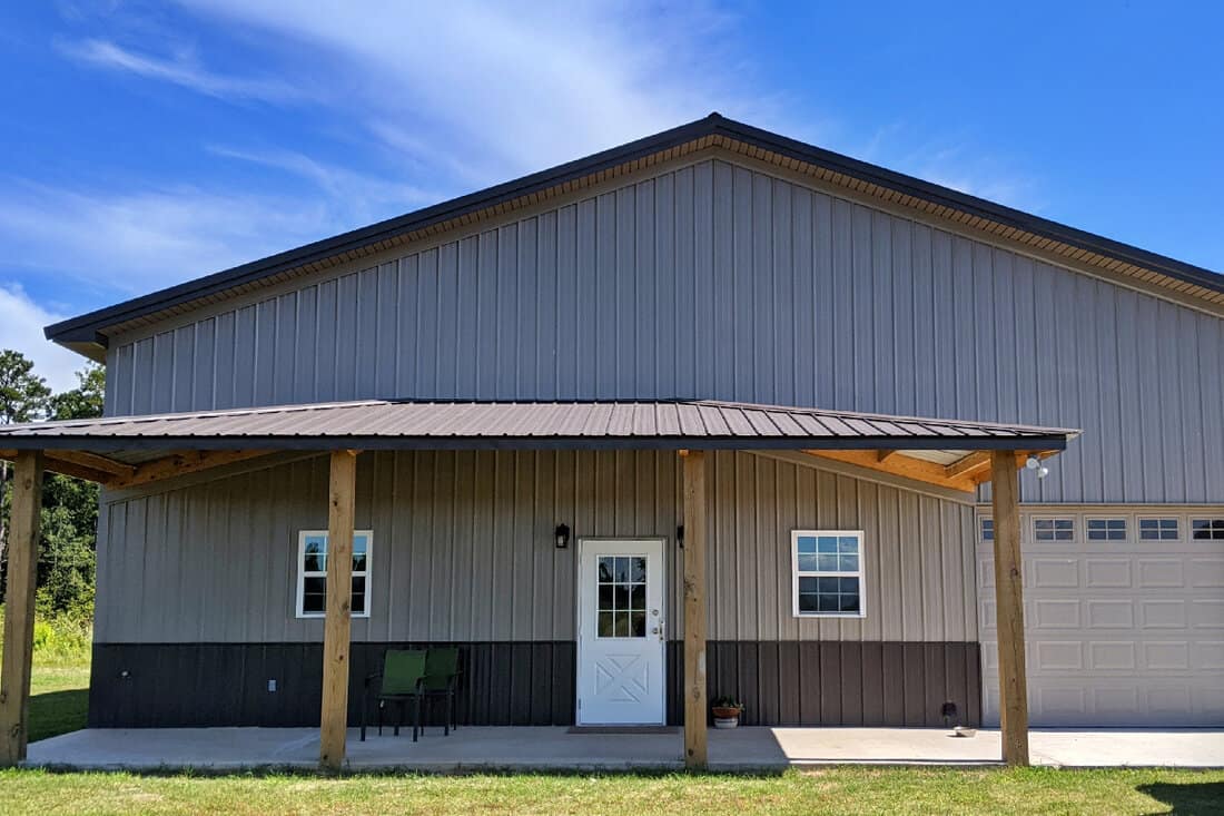 Post frame construction home with metal roof and metal siding