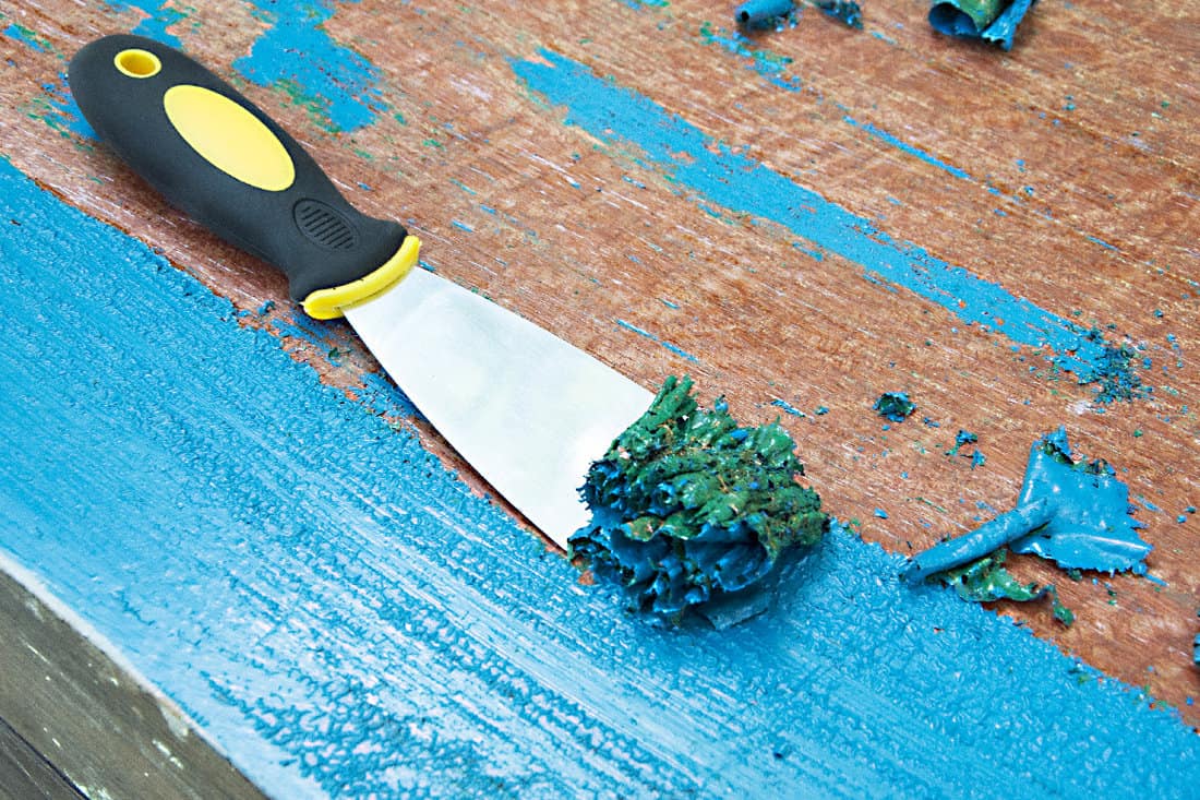 Removing blue painting with spatula