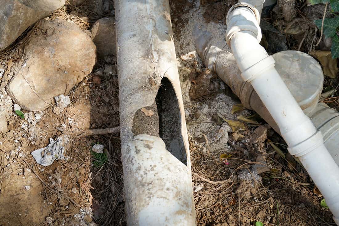 Repair and replacement of broken waste water pvc plastic sewer pipe, drainage of waste water from the house. Close-up 