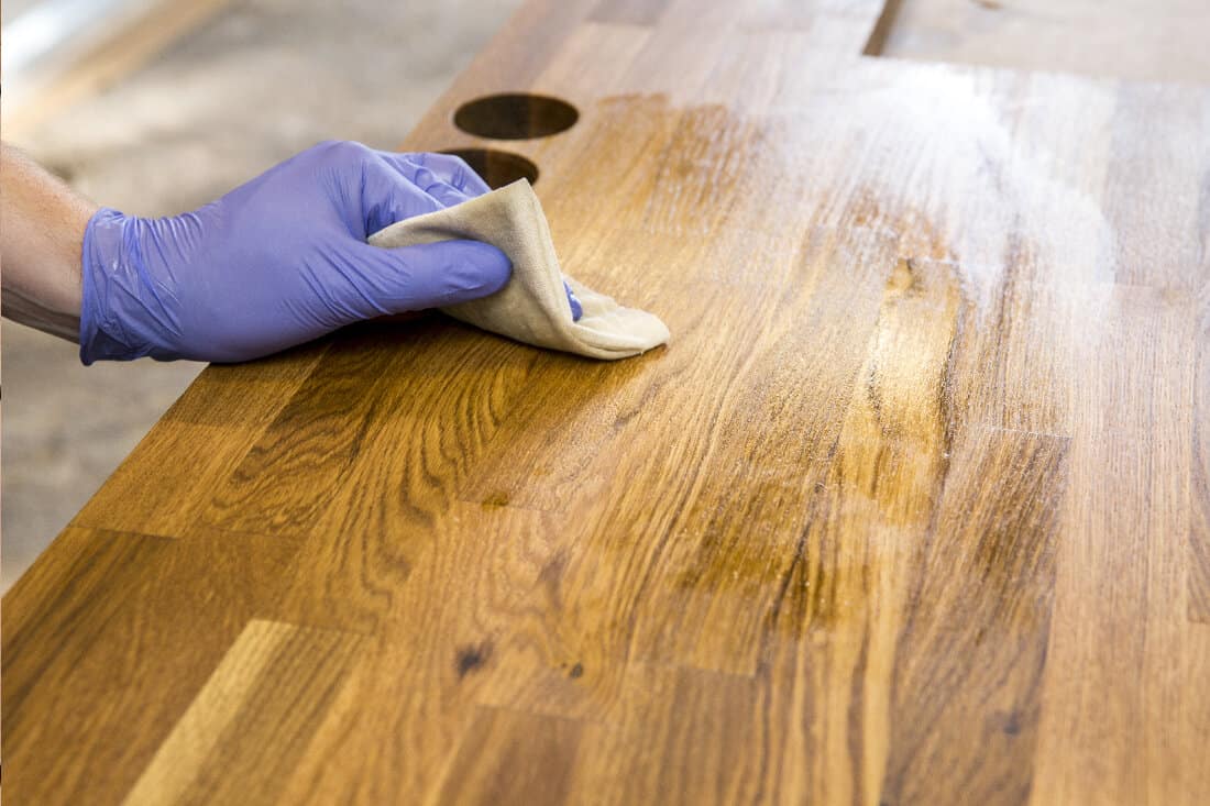 Rubbing oiling with linseed oil natural wooden kitchen countertop before using