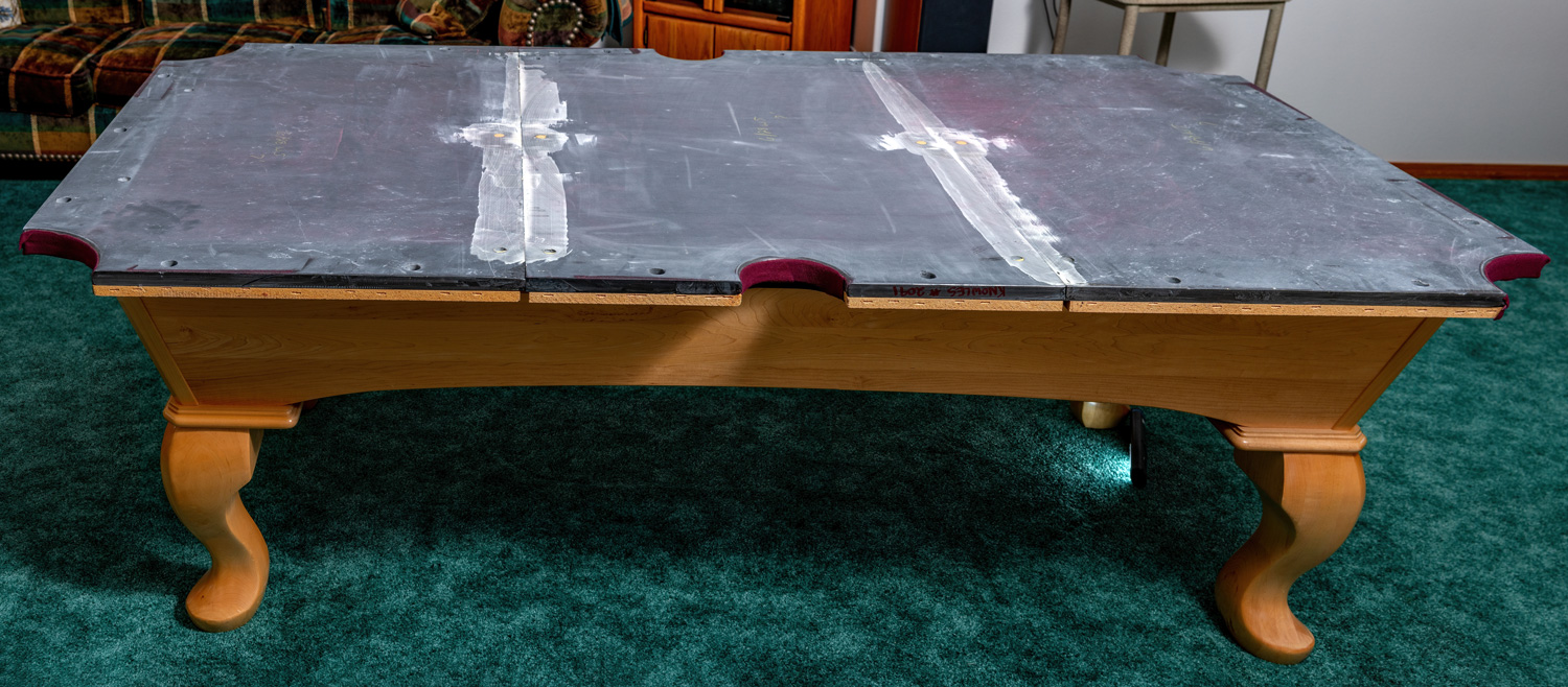 Slate slabs on a pool table on a maple wood frame 