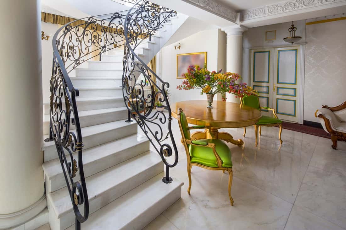 Staircase with handmade wrought Iron Railing. luxury lobby interior.