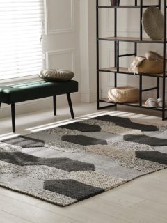 Stylish carpet with pattern on floor in room, How Many Rugs Are Too Many?