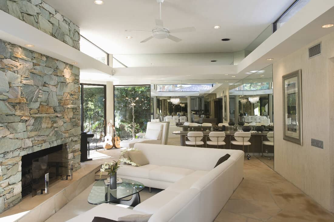Sunken seating area and stone fireplace with dining area