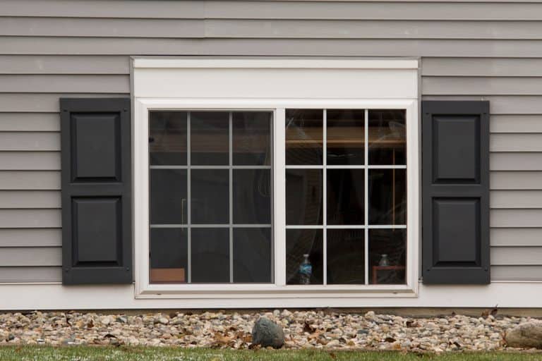 Two pane vinyl window with shutters on a vinyl siding house, How To Remove Shutters From Vinyl Siding [Step By Step Guide]