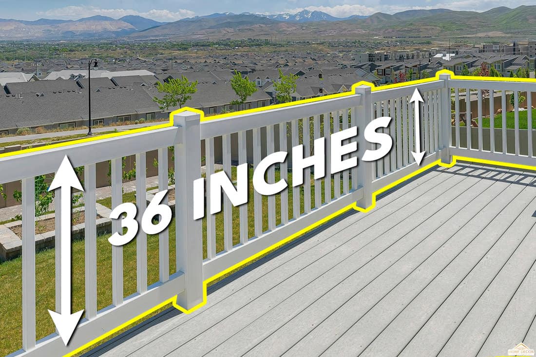 Wooden deck of a house with white railings and a view of the backyard, Should A Deck Railing Be Attached To The House?